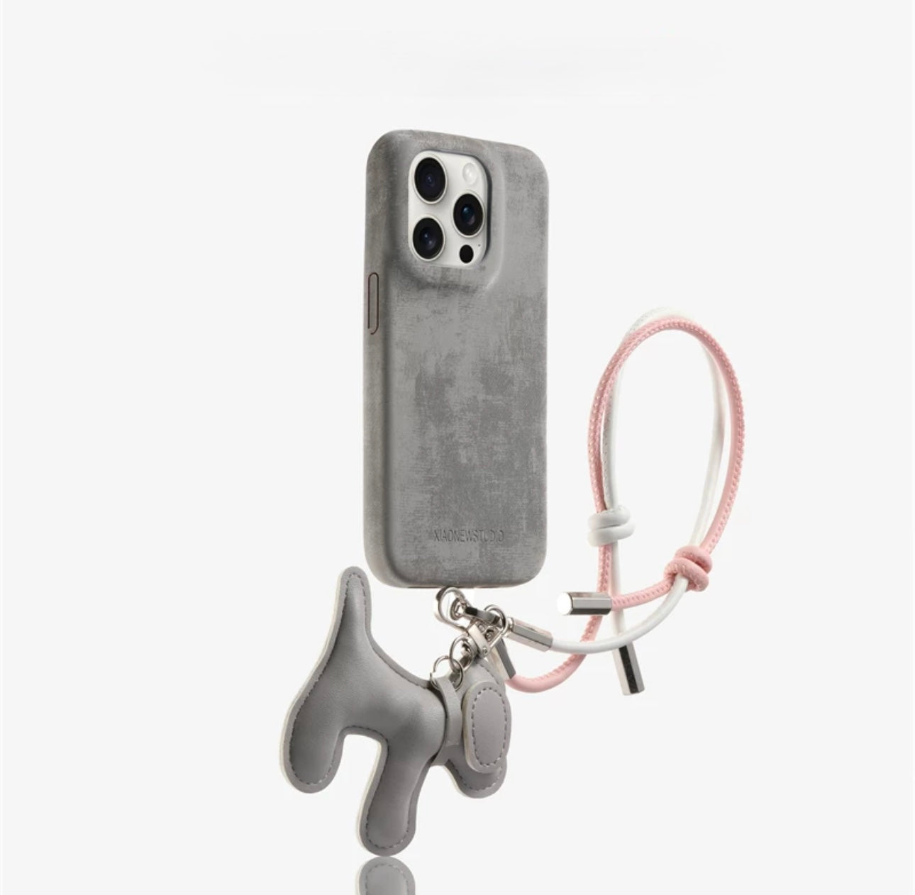 Suede phone case with dog-shaped charm