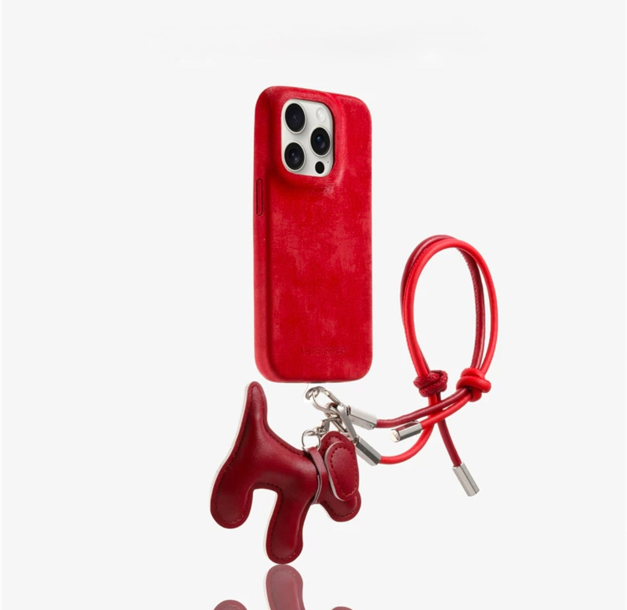 Suede phone case with dog-shaped charm